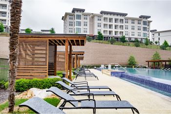relaxing poolside lounging area at Reveal Skyline apartments